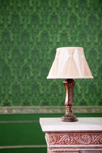 Vintage lamp on chimney on green retro pattern background
