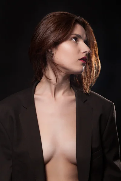 Woman in suit in fashion posing on black background