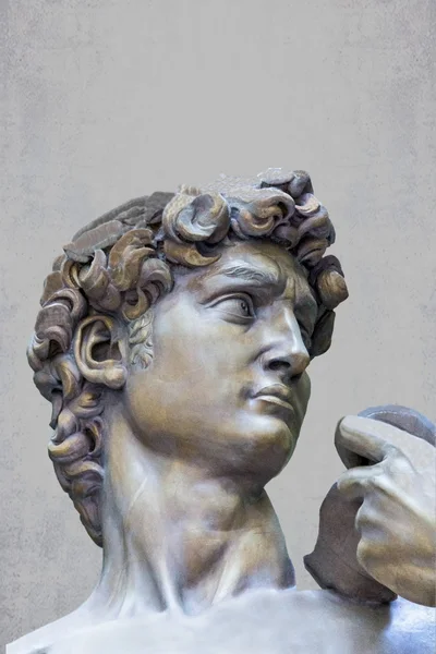 Detail close-up of Michelangelo's David statue on grunge background