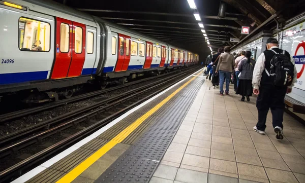 Unidentified people near  train at platform of the King's Cross underground station. London. UK