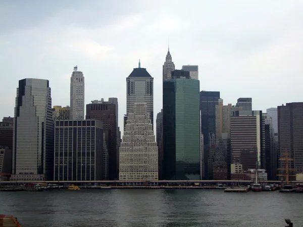 Lower Manhattan silhouette on the cloudy sky background