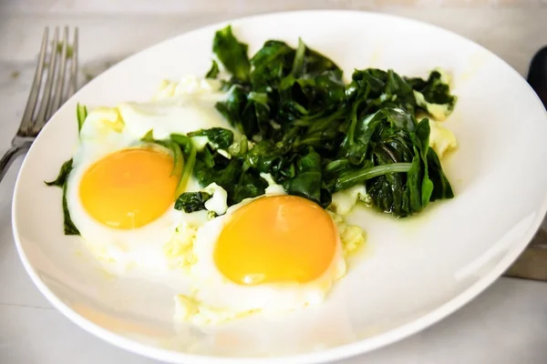 Creamy spinach with fried egg. Healthy breakfast