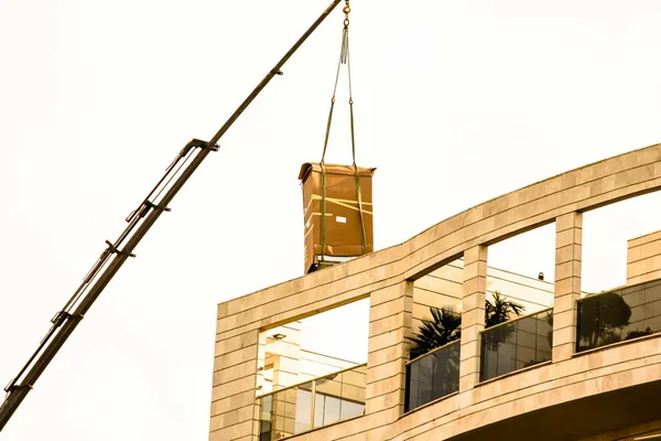 Delivery of the refrigerator in  original packaging to the penthouse via truck crane