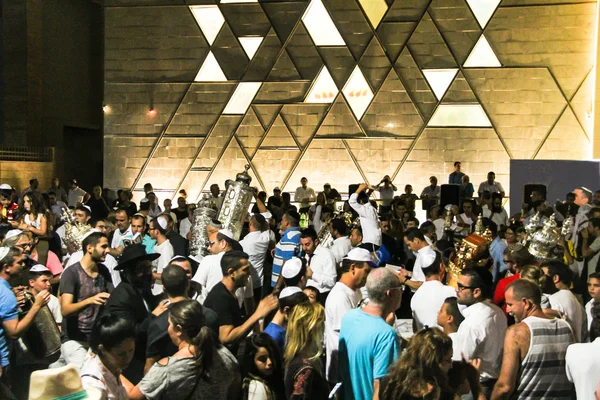 Men dance with Bible scrolls during the ceremony of Simhath Torah. Tel Aviv. Israel