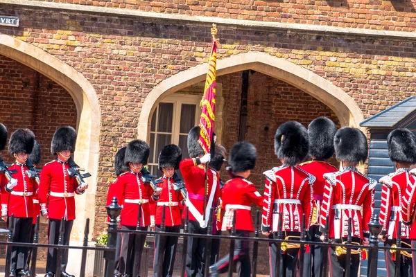 The ceremonial flag removal. British guardsmen preparing for the parade opposite St. James Palace.