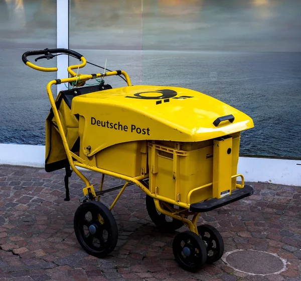 Postman mail delivery cart in yellow for home delivery