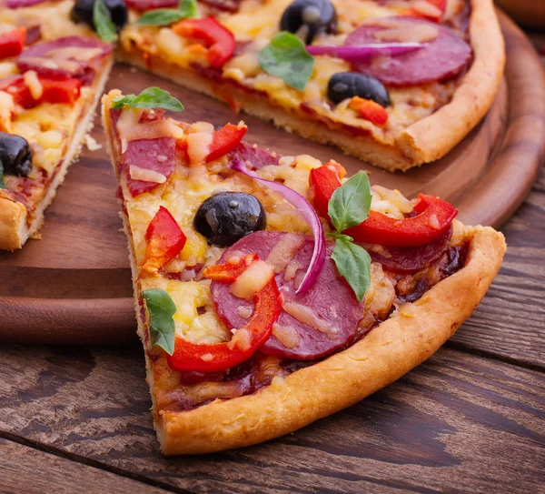 Pizza with tomato, salami and olives