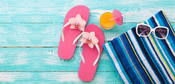 Summer vacation. Pink sandals by swimming pool.