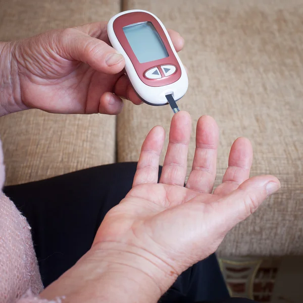 Woman makes testing high blood sugar.