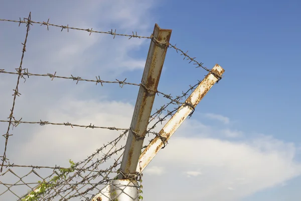 Barbed wire on blue sky background