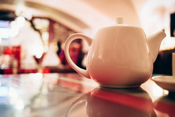 White teapot at restaurant close up.