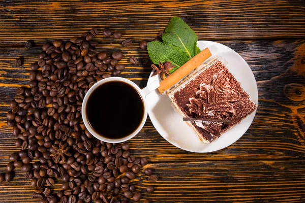 Cake slice in plate with coffee and beans