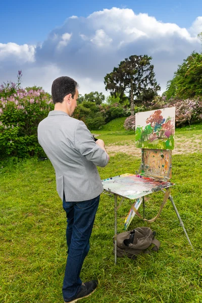 Lonely professional fashionable male painter working outdoors in