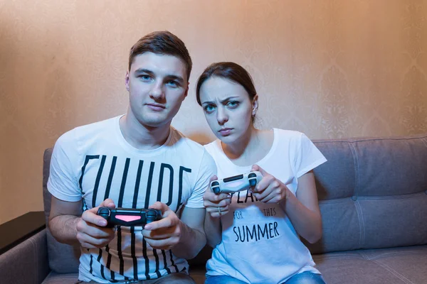 Portrait of young couple playing video game