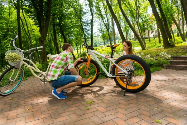 Young couple trying to fix a bike