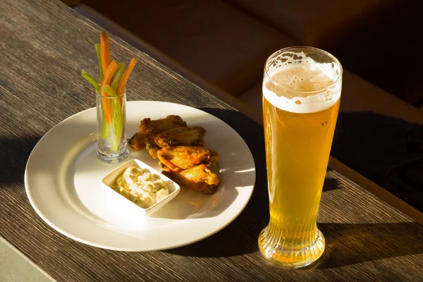 Glass of Beer and Plate of Chicken Wings