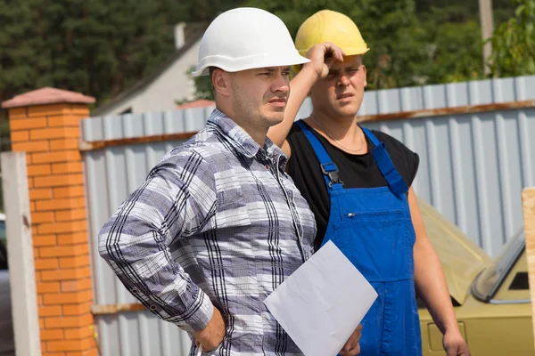 Engineer and building contractor on site