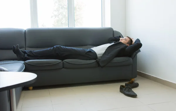 Young Office Man Lying on Couch During Break