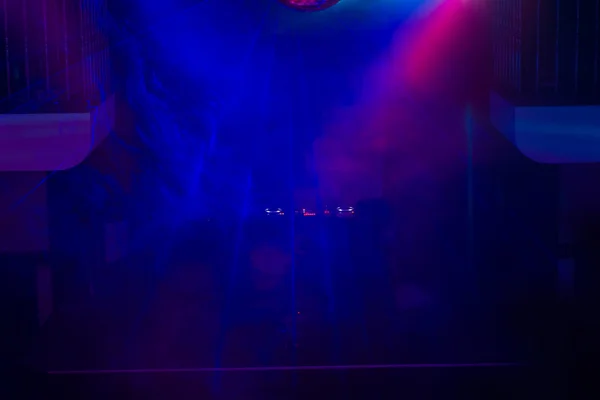 DJ and Turntable on Stage in Night Club