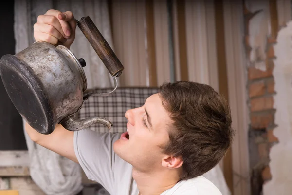 Close up Young Man Drinking From Vintage Kettle