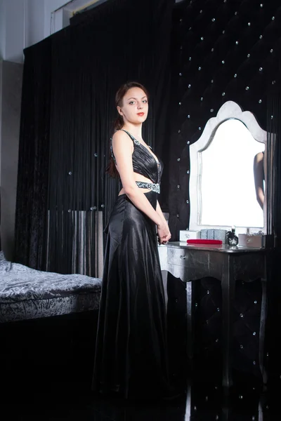Smiling Woman in Elegant Black Dress at her Room