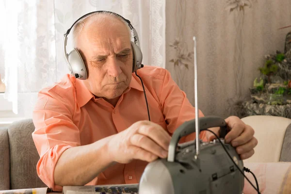 Sitting Old Man Listening News at the Radio