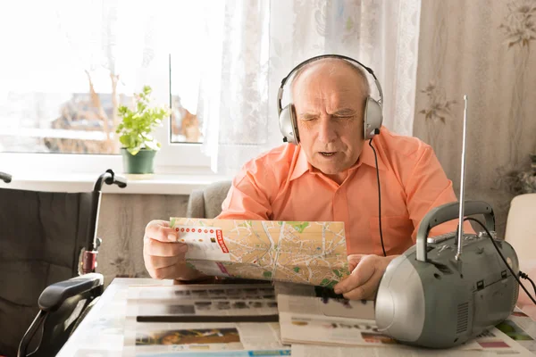 Old Man Listening Music From Radio While Reading