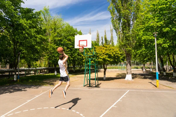 Athletic Man Taking Jump Shot on Basketball Court