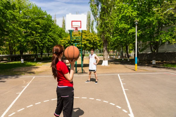 Couple Playing Basketball on Outdoor Court