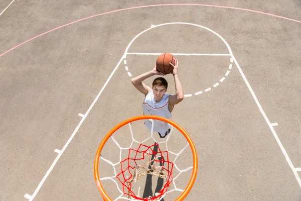Young Man Making Jump Shot on Basketball Court