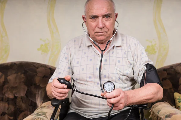 Senior Man with Sphygmomanometer and Stethoscope