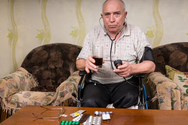 Senior Man Holding Healthy Juice and BP Apparatus