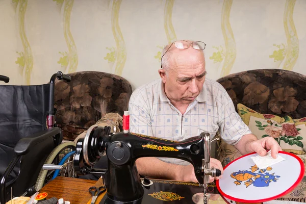 Senior Man Doing Needle Point with Sewing Machine