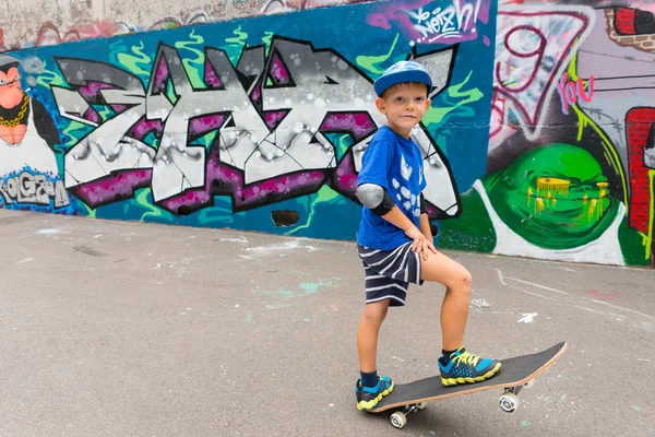 Boy Standing on Skateboard in Urban Skate Park