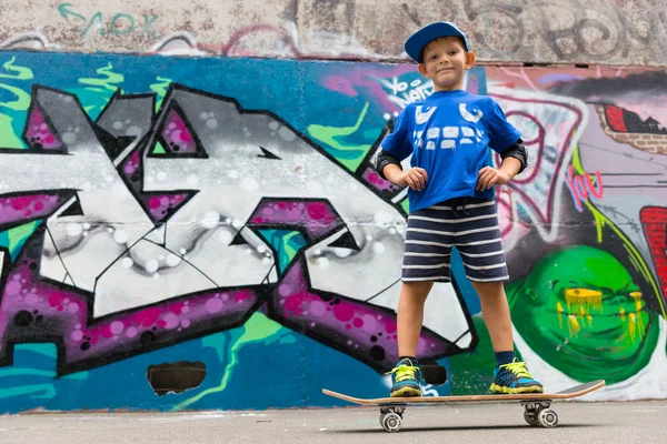 Confident Boy on Skateboard with Hands on Hips