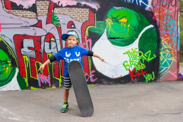 Boy with Skateboard Standing with Open Arms