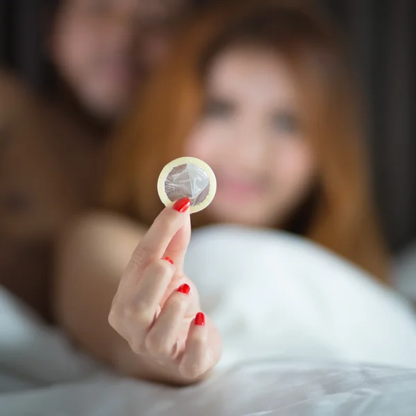 Woman showing a condoms