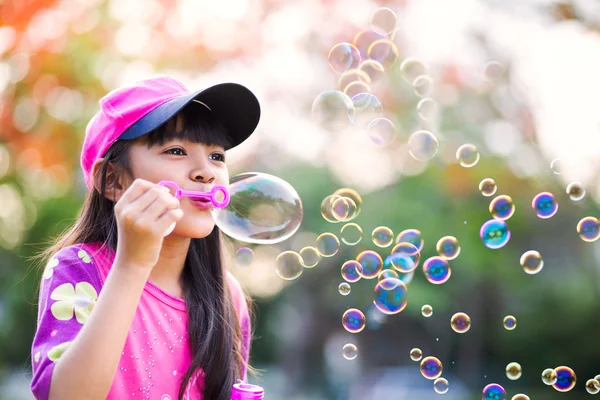 Blowing soap bubbles