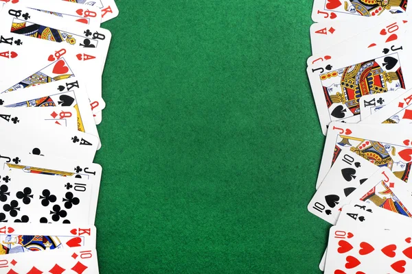 Playing cards isolated on green background