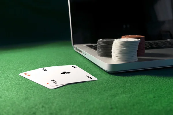 Laptop, poker cards and poker chips
