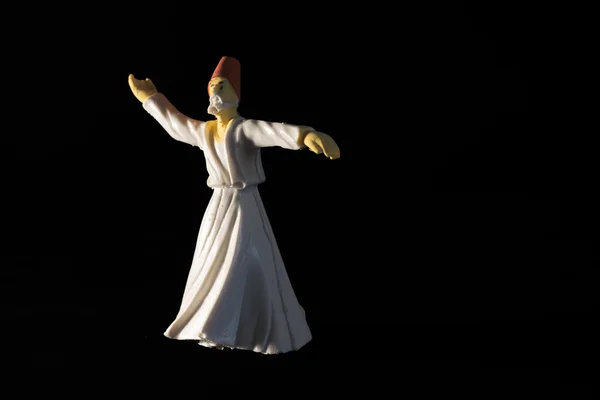 Whirling dervish isolated on black background