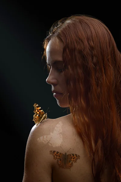 Redhead girl with butterfly