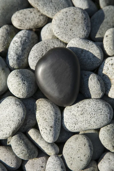 Basalt stone heart on pebbles