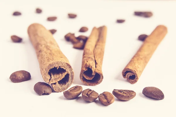 Close up of cinnamon sticks and coffee beans.