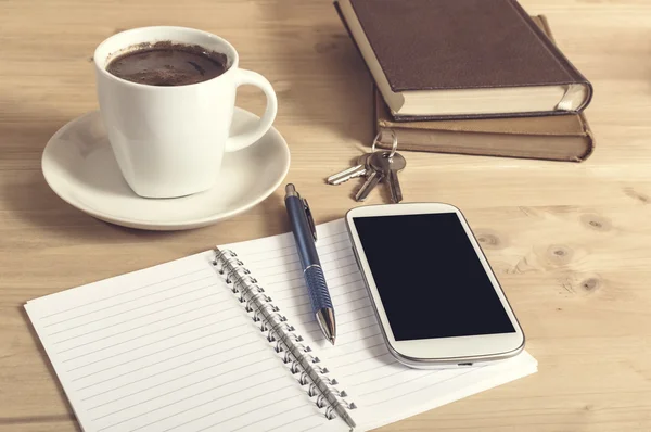 Still life photo of smartphone, notebook, coffee, book, pencil a