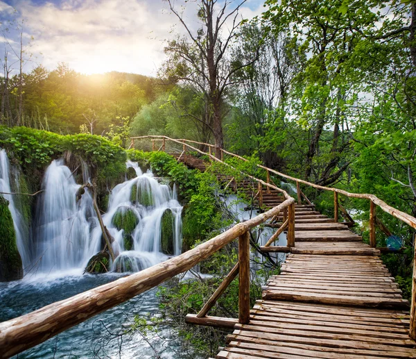 Beautiful view of waterfalls and pathway in Plitvice Lakes National Park.