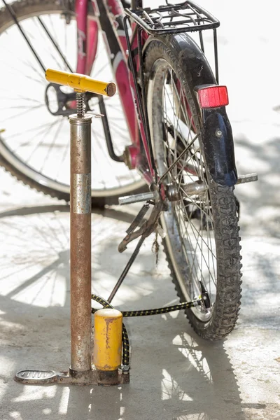 Old air pump and bicycle tire.