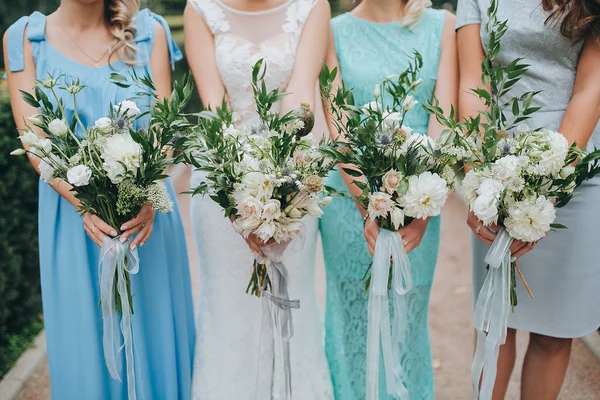 Bride and bridesmaids holding bouquets