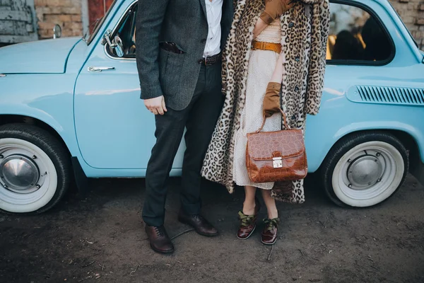 Guy and girl near blue car