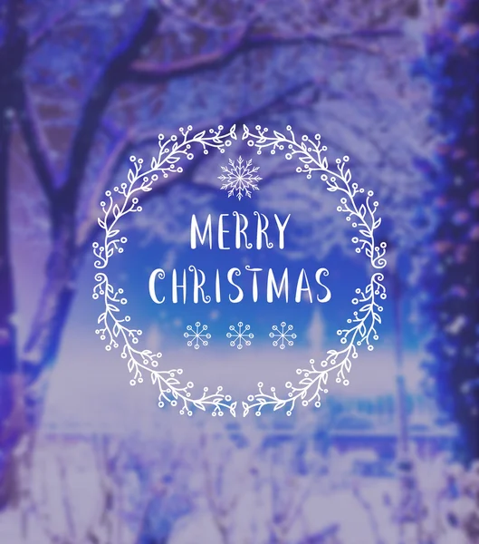 Merry Christmas lettering on defocused blue winter background. Holiday design.